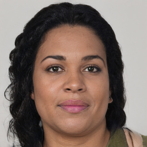 Joyful black young-adult female with medium  brown hair and brown eyes