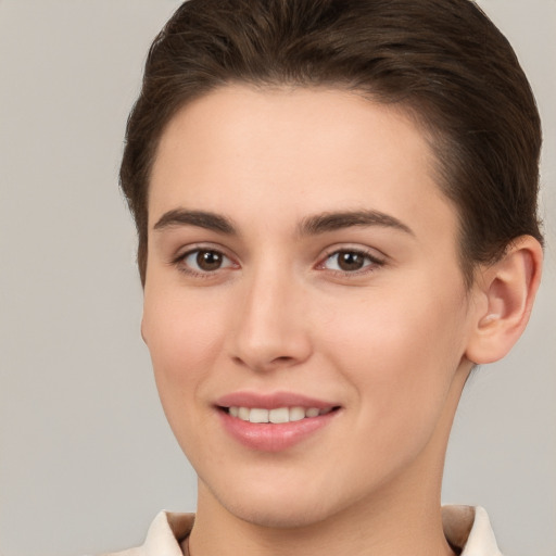 Joyful white young-adult female with short  brown hair and brown eyes