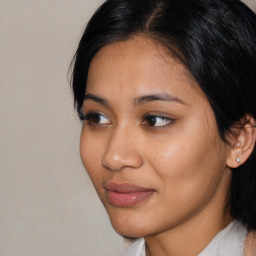 Joyful latino young-adult female with medium  black hair and brown eyes