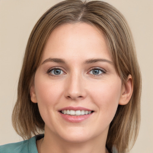 Joyful white young-adult female with medium  brown hair and green eyes