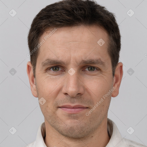 Joyful white adult male with short  brown hair and brown eyes