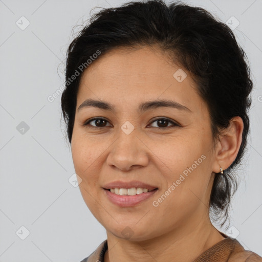 Joyful latino young-adult female with medium  brown hair and brown eyes