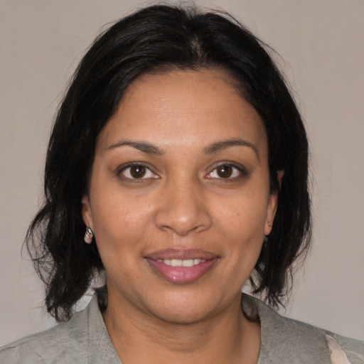Joyful black adult female with medium  brown hair and brown eyes