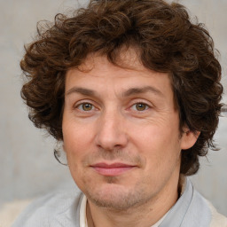 Joyful white adult male with medium  brown hair and brown eyes