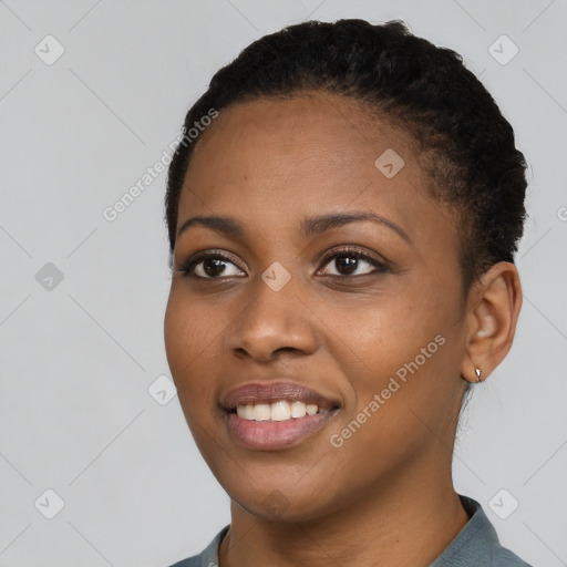 Joyful black young-adult female with short  black hair and brown eyes