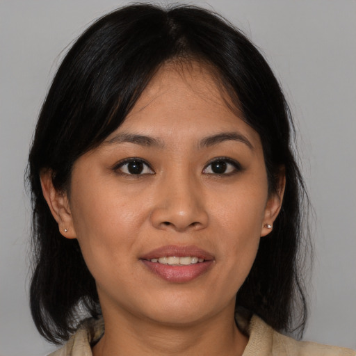 Joyful asian young-adult female with medium  brown hair and brown eyes
