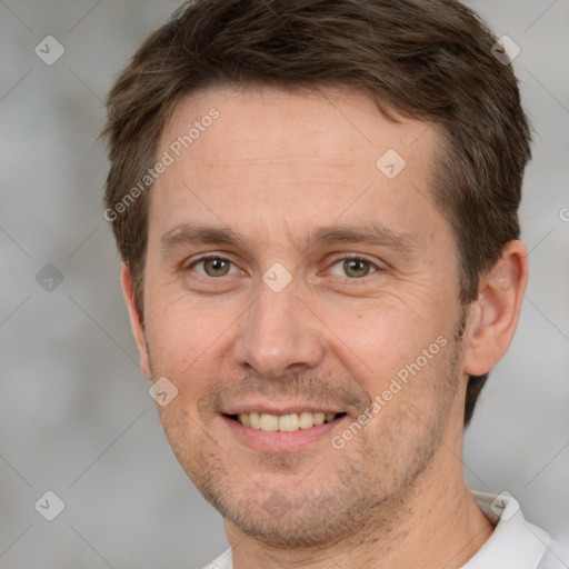 Joyful white adult male with short  brown hair and brown eyes