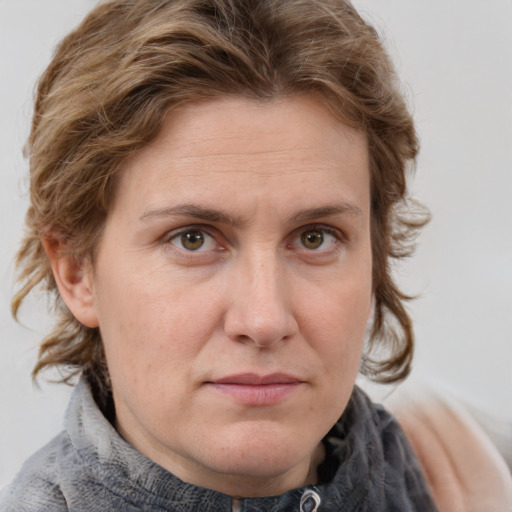 Joyful white adult female with medium  brown hair and grey eyes