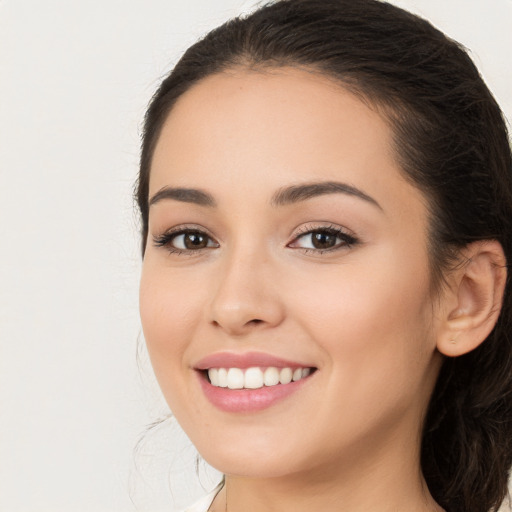 Joyful white young-adult female with long  brown hair and brown eyes