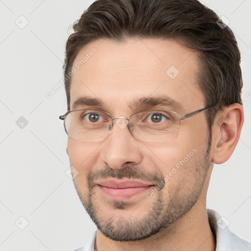 Joyful white adult male with short  brown hair and brown eyes