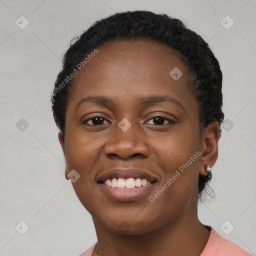 Joyful black young-adult female with short  black hair and brown eyes