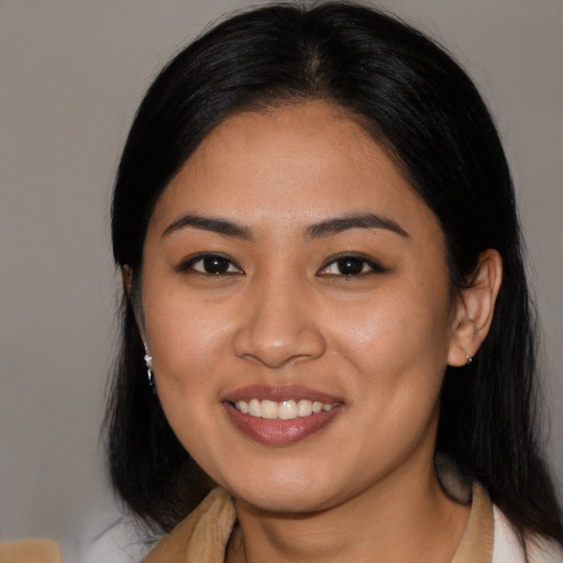 Joyful latino young-adult female with medium  black hair and brown eyes