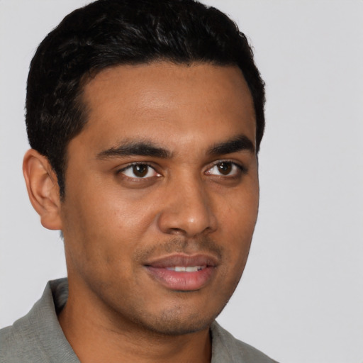 Joyful latino young-adult male with short  black hair and brown eyes