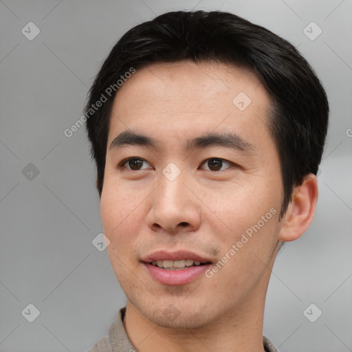 Joyful asian young-adult male with short  black hair and brown eyes