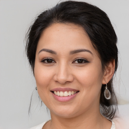 Joyful latino young-adult female with medium  brown hair and brown eyes