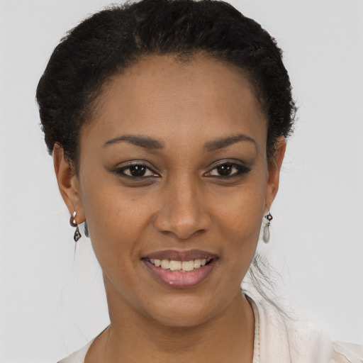 Joyful black young-adult female with short  brown hair and brown eyes