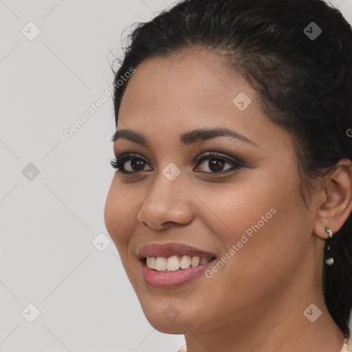 Joyful latino young-adult female with long  brown hair and brown eyes