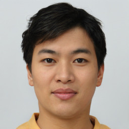 Joyful asian young-adult male with short  black hair and brown eyes