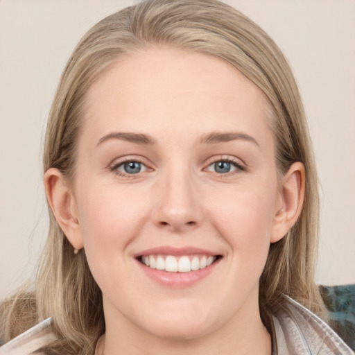 Joyful white young-adult female with long  brown hair and grey eyes