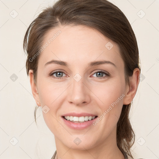 Joyful white young-adult female with medium  brown hair and grey eyes