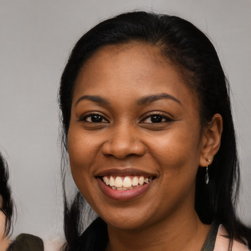 Joyful black young-adult female with medium  black hair and brown eyes