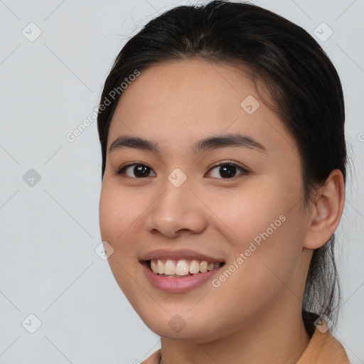 Joyful asian young-adult female with medium  brown hair and brown eyes