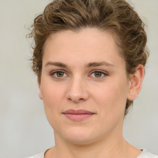 Joyful white young-adult female with medium  brown hair and green eyes