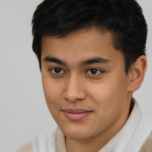 Joyful latino young-adult male with short  brown hair and brown eyes