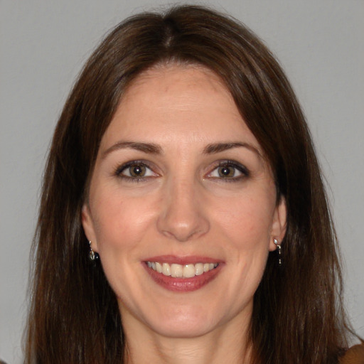 Joyful white adult female with long  brown hair and brown eyes