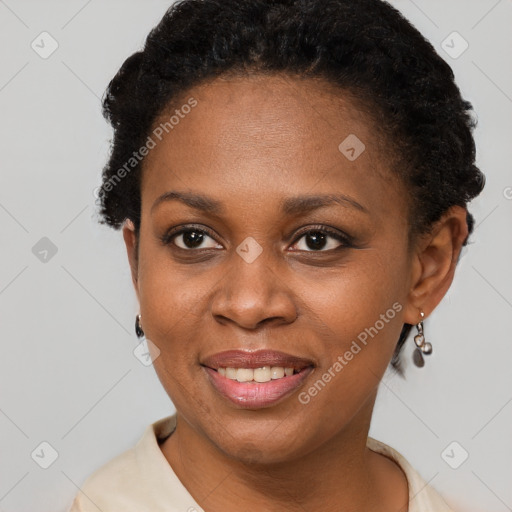 Joyful black young-adult female with short  brown hair and brown eyes