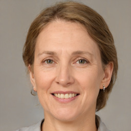 Joyful white adult female with medium  brown hair and grey eyes