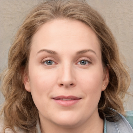 Joyful white young-adult female with medium  brown hair and blue eyes