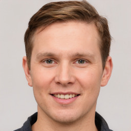 Joyful white young-adult male with short  brown hair and grey eyes