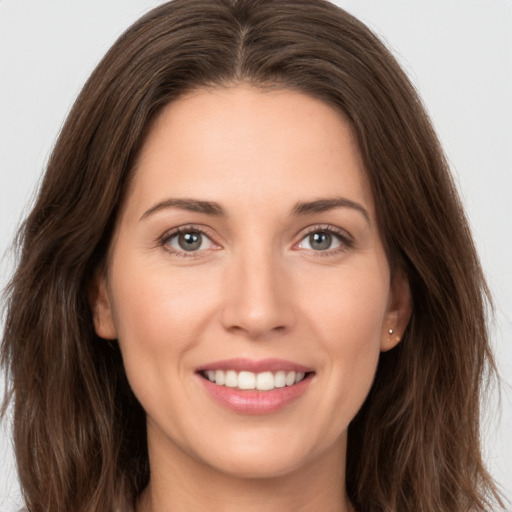 Joyful white young-adult female with long  brown hair and brown eyes