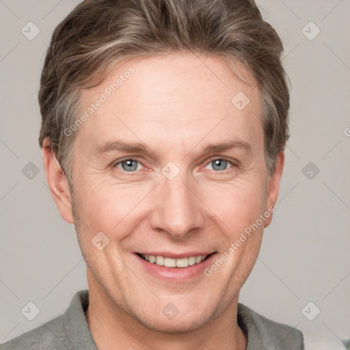 Joyful white adult male with short  brown hair and grey eyes