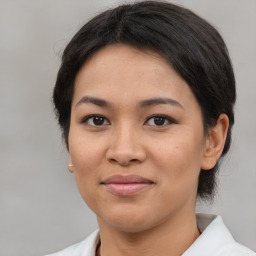 Joyful asian young-adult female with medium  brown hair and brown eyes