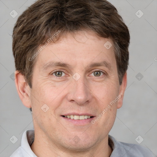 Joyful white adult male with short  brown hair and grey eyes