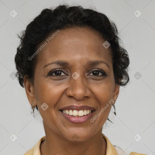 Joyful black adult female with short  brown hair and brown eyes