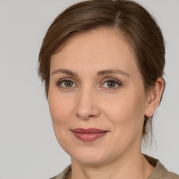 Joyful white adult female with medium  brown hair and grey eyes