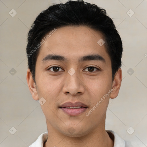 Joyful latino young-adult male with short  black hair and brown eyes