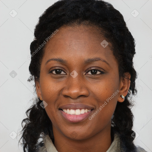 Joyful black young-adult female with long  black hair and brown eyes