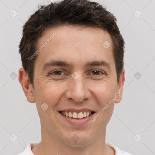 Joyful white adult male with short  brown hair and brown eyes