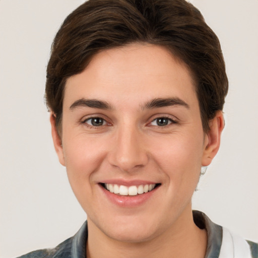 Joyful white young-adult female with short  brown hair and brown eyes