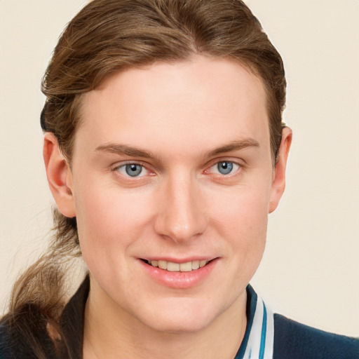 Joyful white young-adult male with short  brown hair and blue eyes