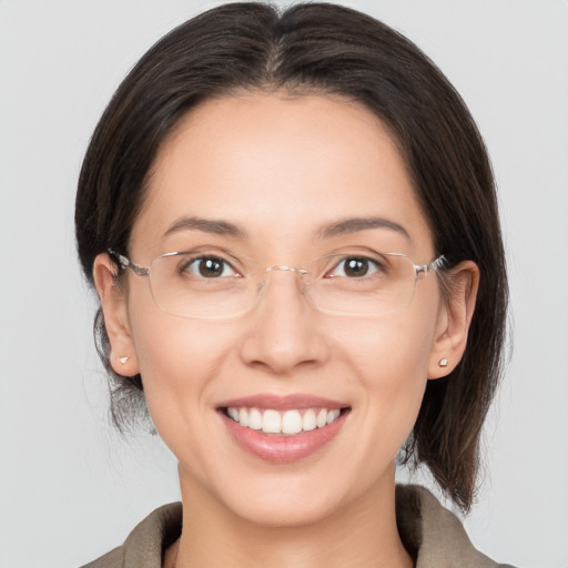 Joyful white adult female with medium  brown hair and brown eyes