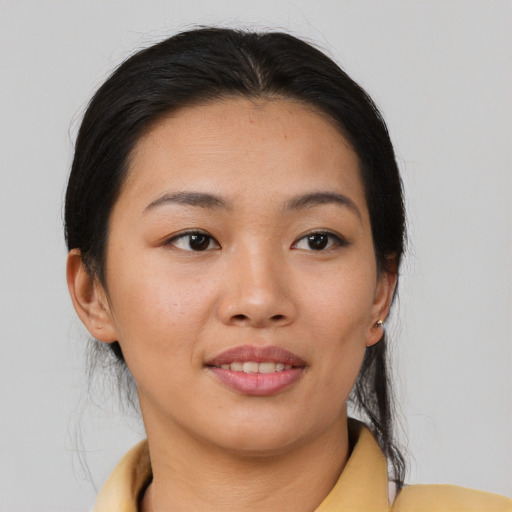 Joyful asian young-adult female with medium  brown hair and brown eyes