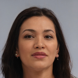 Joyful latino young-adult female with long  brown hair and brown eyes