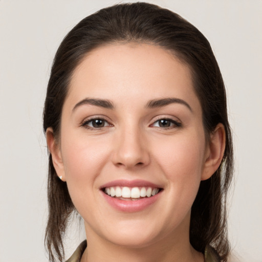 Joyful white young-adult female with medium  brown hair and brown eyes