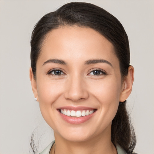 Joyful white young-adult female with medium  brown hair and brown eyes