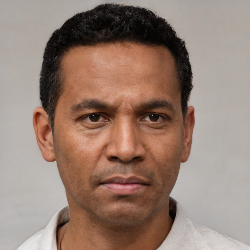 Neutral latino adult male with short  black hair and brown eyes